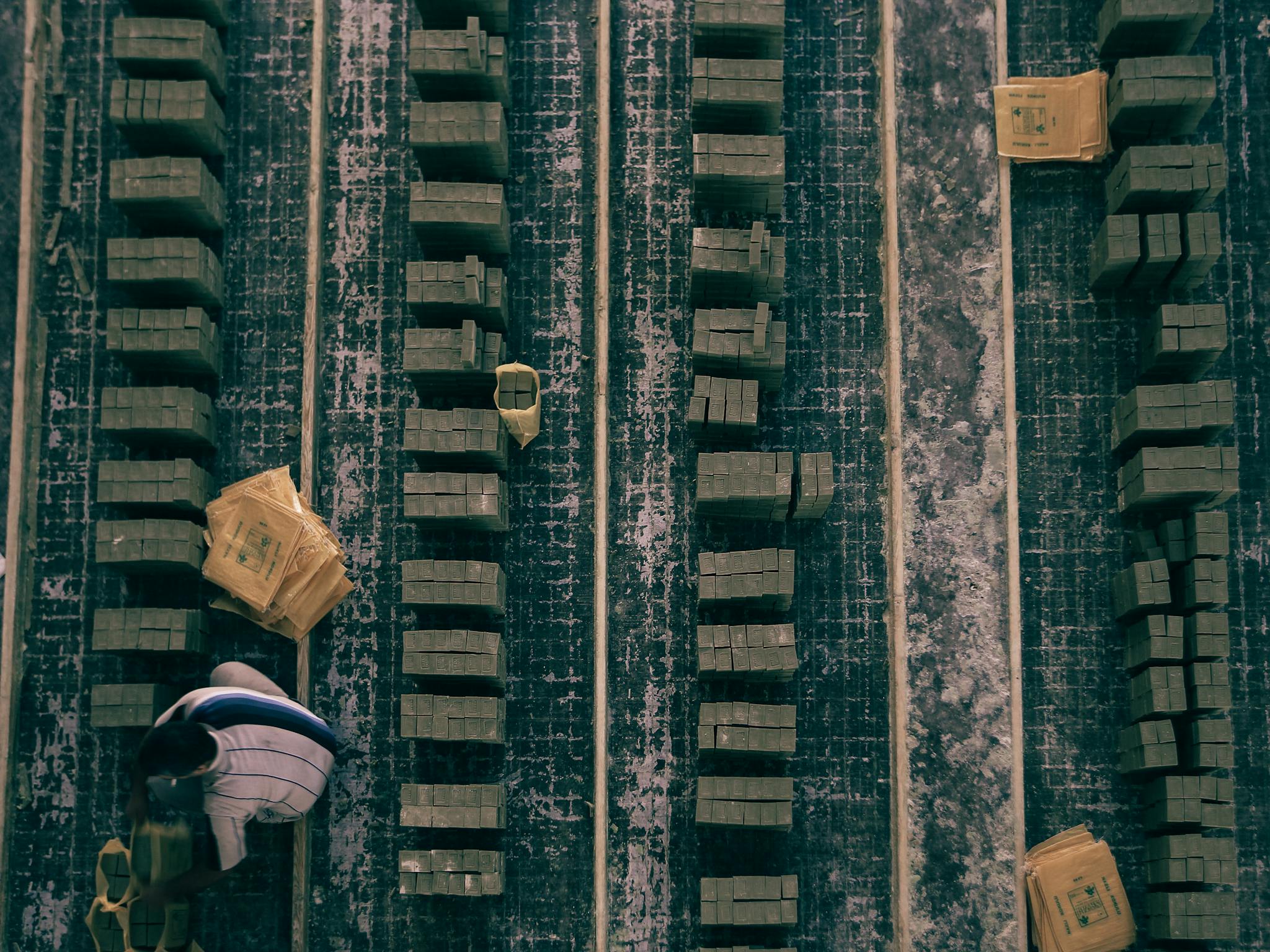 Top view of stacked wooden blocks in an industrial setting, showcasing alignment and organization.